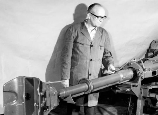 Man standing with one of first Dellner automatic couplers produced in Sweden